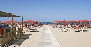 On the beach, beach cabanas, sun loungers, beach umbrellas