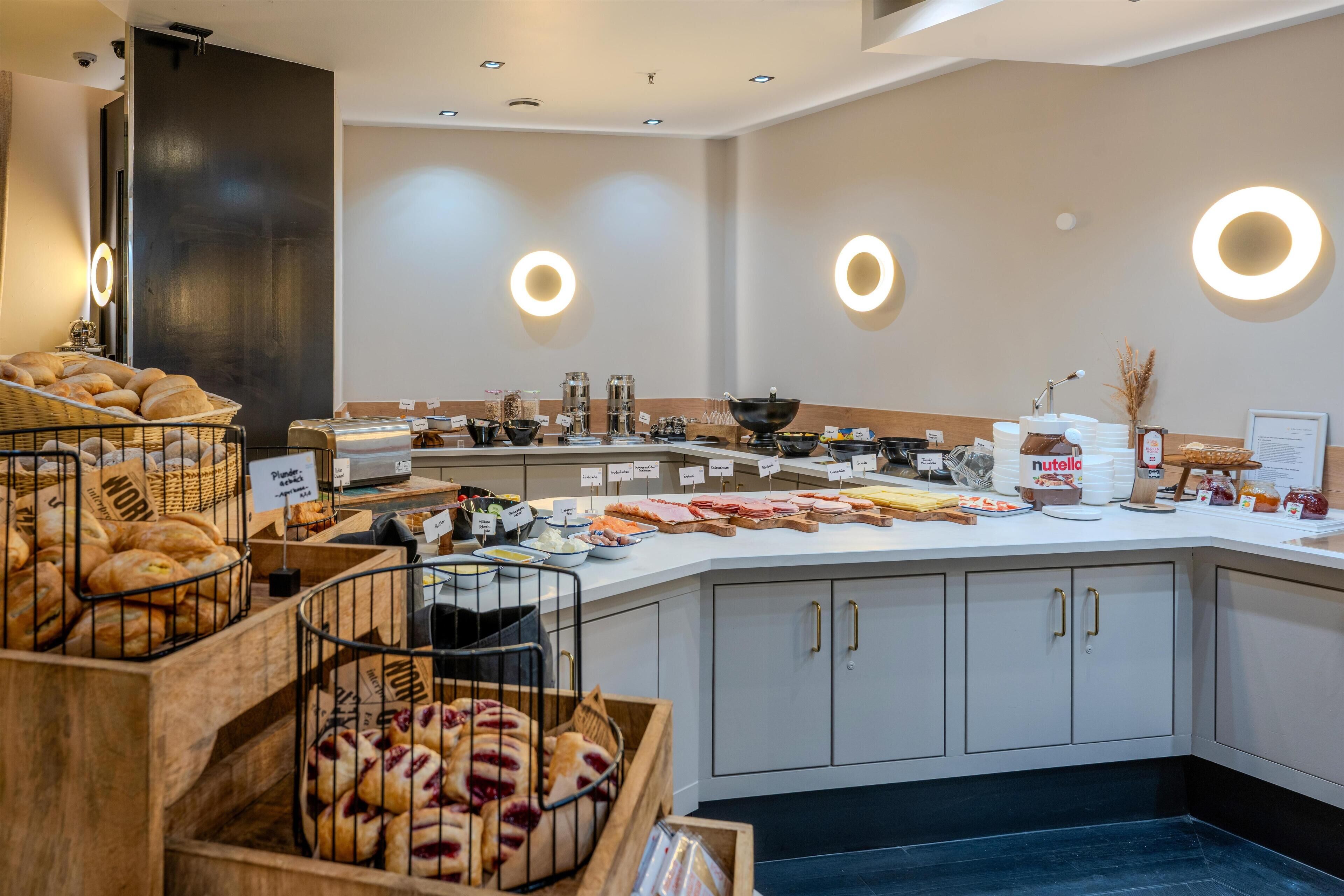 A breakfast buffet with various food items and a coffee station.