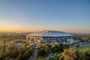 A stadium with a large, curved roof and multiple entry points.