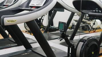 A stationary bike with a digital display and a foot pedal.