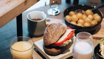 A breakfast buffet with various food items and beverages.