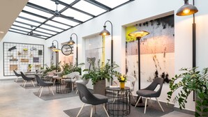 Un interior moderno con techo alto, tragaluces y mobiliario contemporáneo.