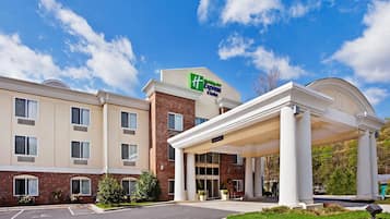 Welcome to Wyndham Express Suites, a hotel with a brick facade and covered entrance.