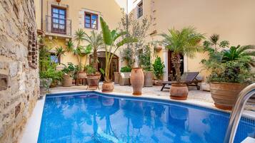 Seasonal outdoor pool, open 10:30 AM to 6:30 PM, sun loungers