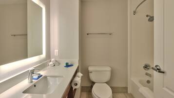 A modern bathroom with a white sink, toilet, and bathtub.