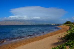 On the beach, white sand, beach umbrellas, beach towels