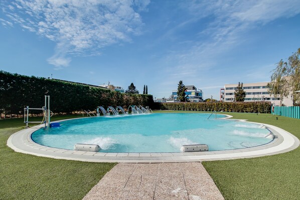 Seasonal outdoor pool, open 10:00 AM to 9:00 PM, pool loungers