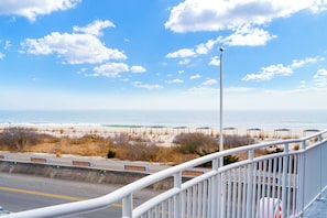 A coastal road with benches and a beach in the background. - Montreal Beach Resort (Cape May)