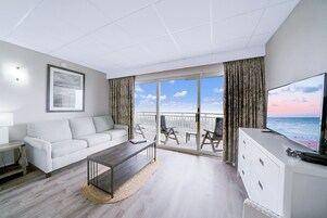 Deluxe Two Double Bed Suite with Kitchenette, Oceanfront | Living area | Flat-screen TV