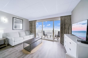 Deluxe Two Double Bed Suite with Kitchenette, Oceanfront | Living area | Flat-screen TV