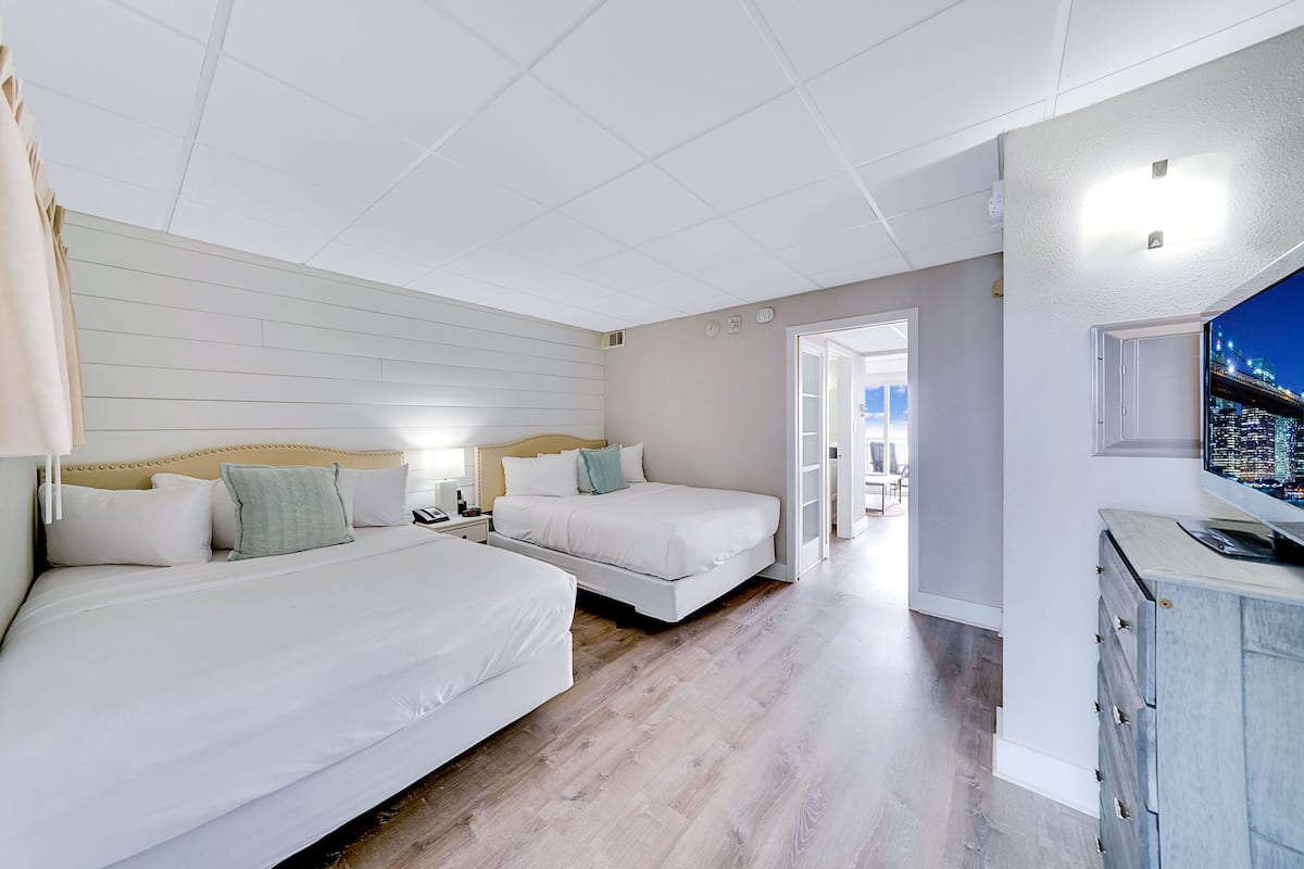 two queen suite with kitchenette (opens to sun deck) | in-room safe, free cots/infant beds, bed sheets