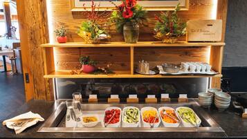 A buffet setup with various food items and a decorative centerpiece.