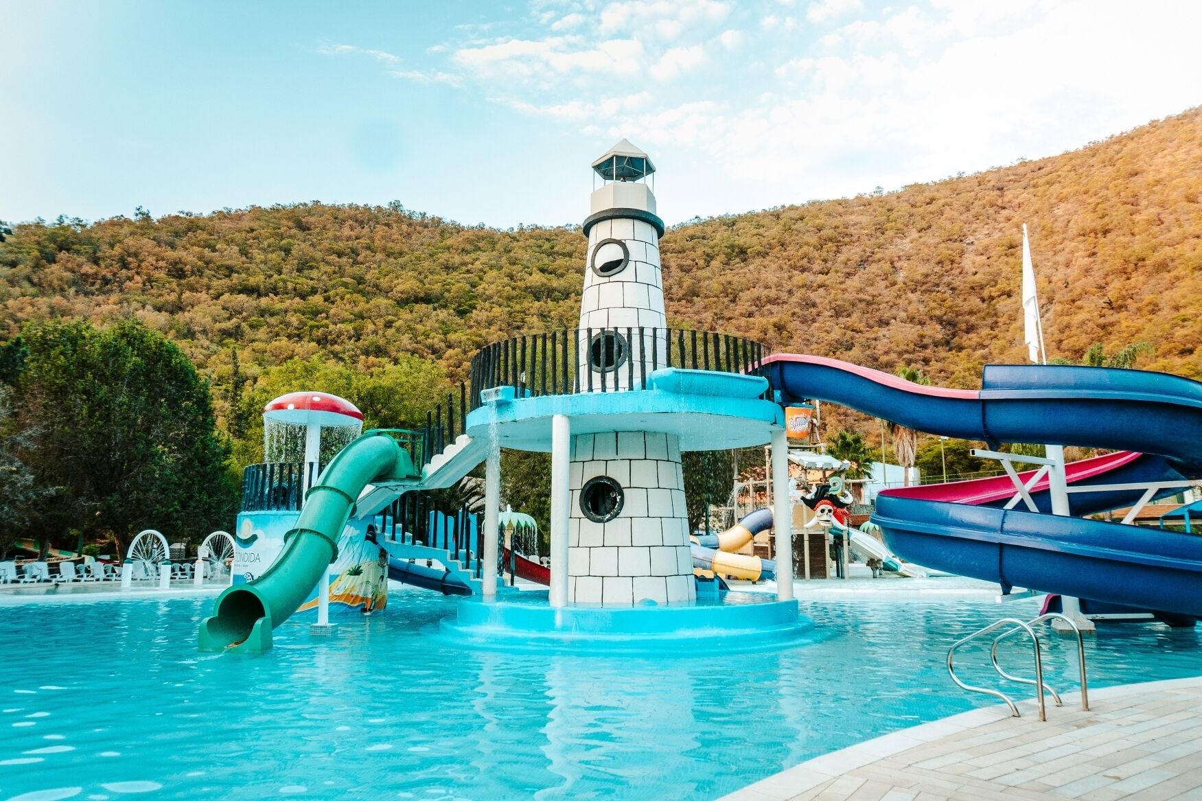 A water park with slides and a lighthouse structure.