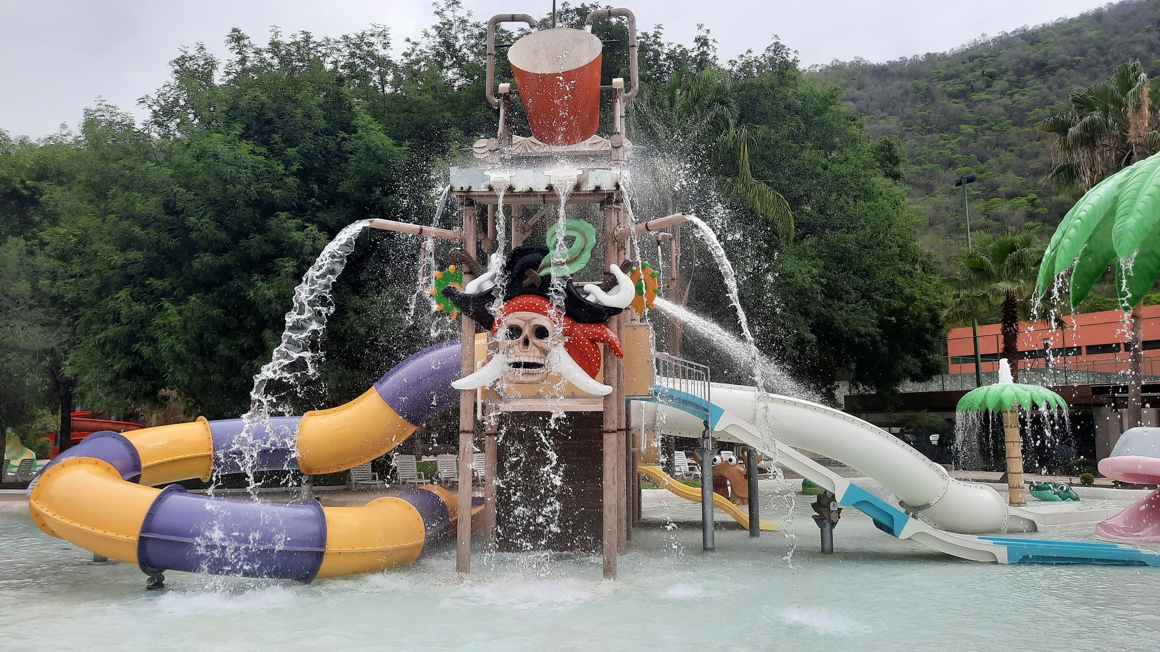 A water play area with slides and a water fountain.