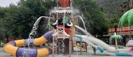 A water play area with slides and a water fountain.