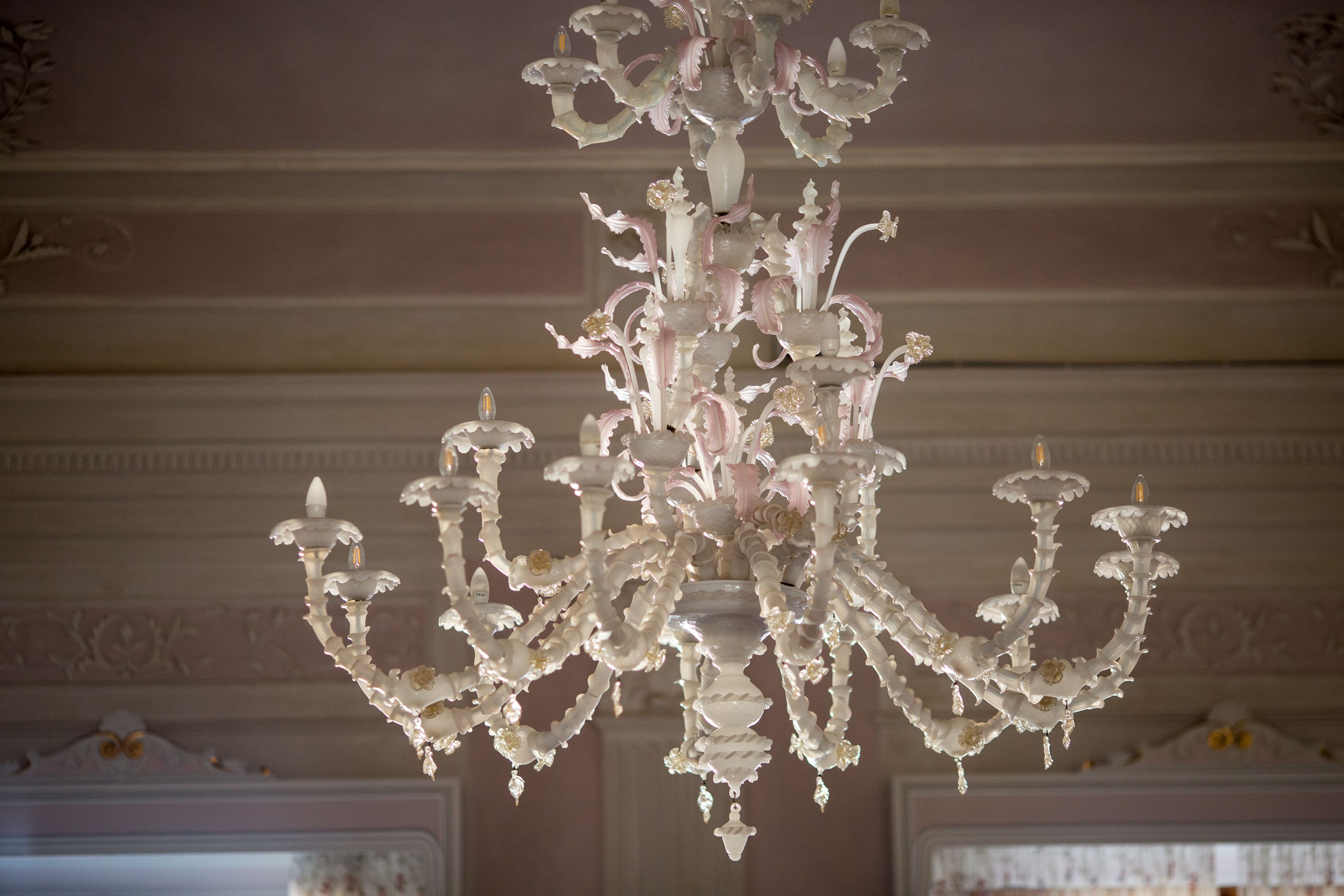 A chandelier with multiple arms and candle-like lights.