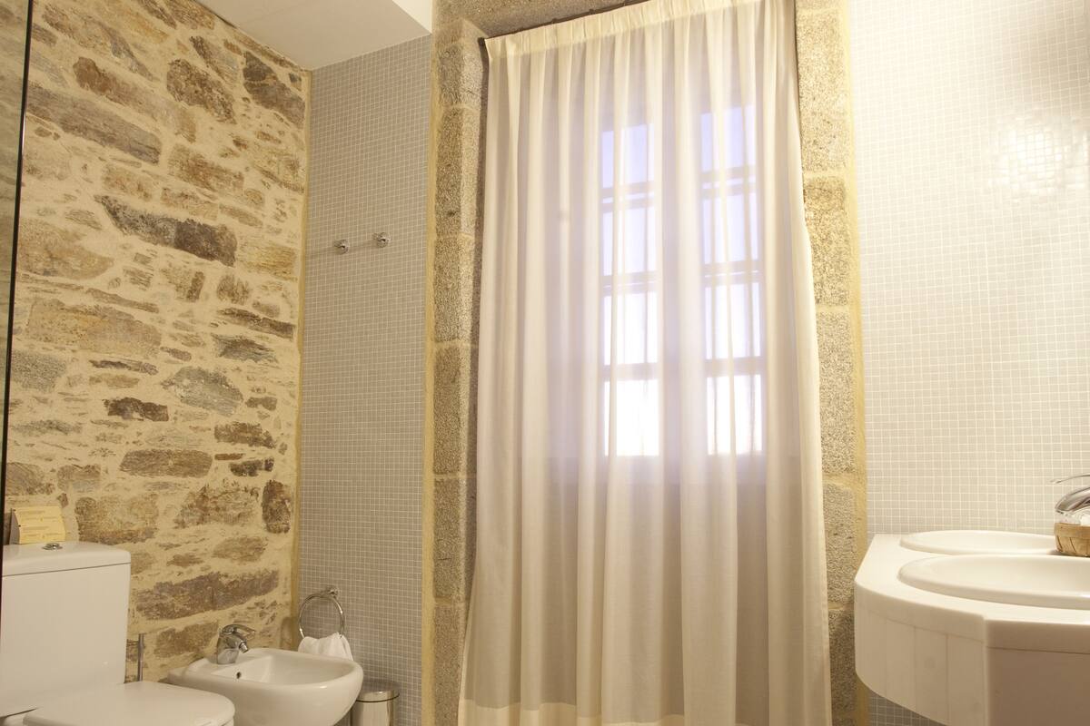 bathtub, hair dryer, bidet, towels
