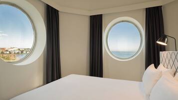 Junior Suite, Sea View | Down duvets, minibar, in-room safe, desk