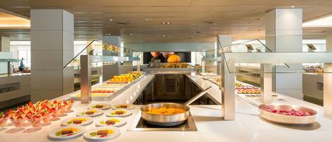 A buffet setup with various food items and a central serving area.
