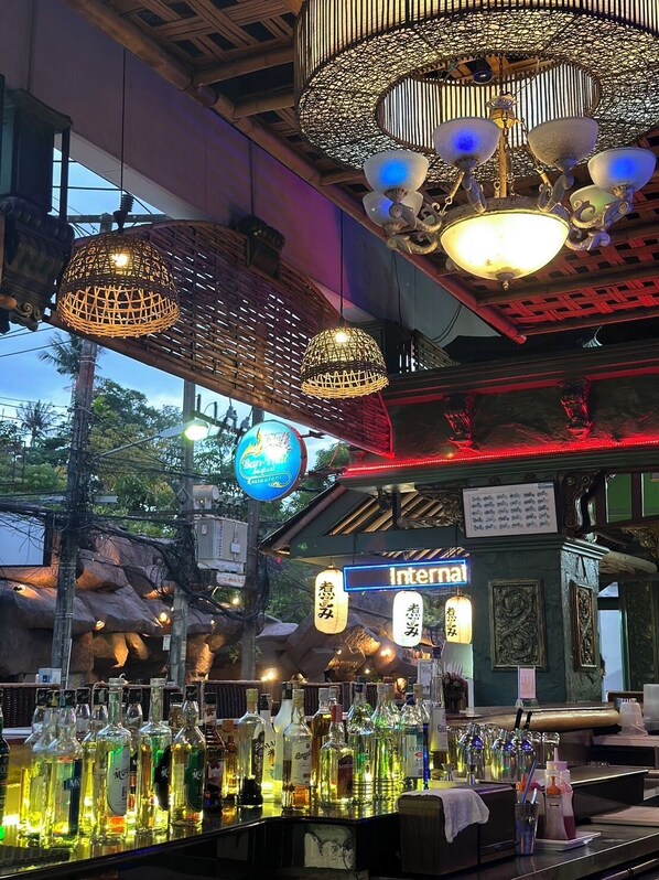 A bar with various bottles and a sign that reads "Internal". - Kata Garden Resort (Karon)