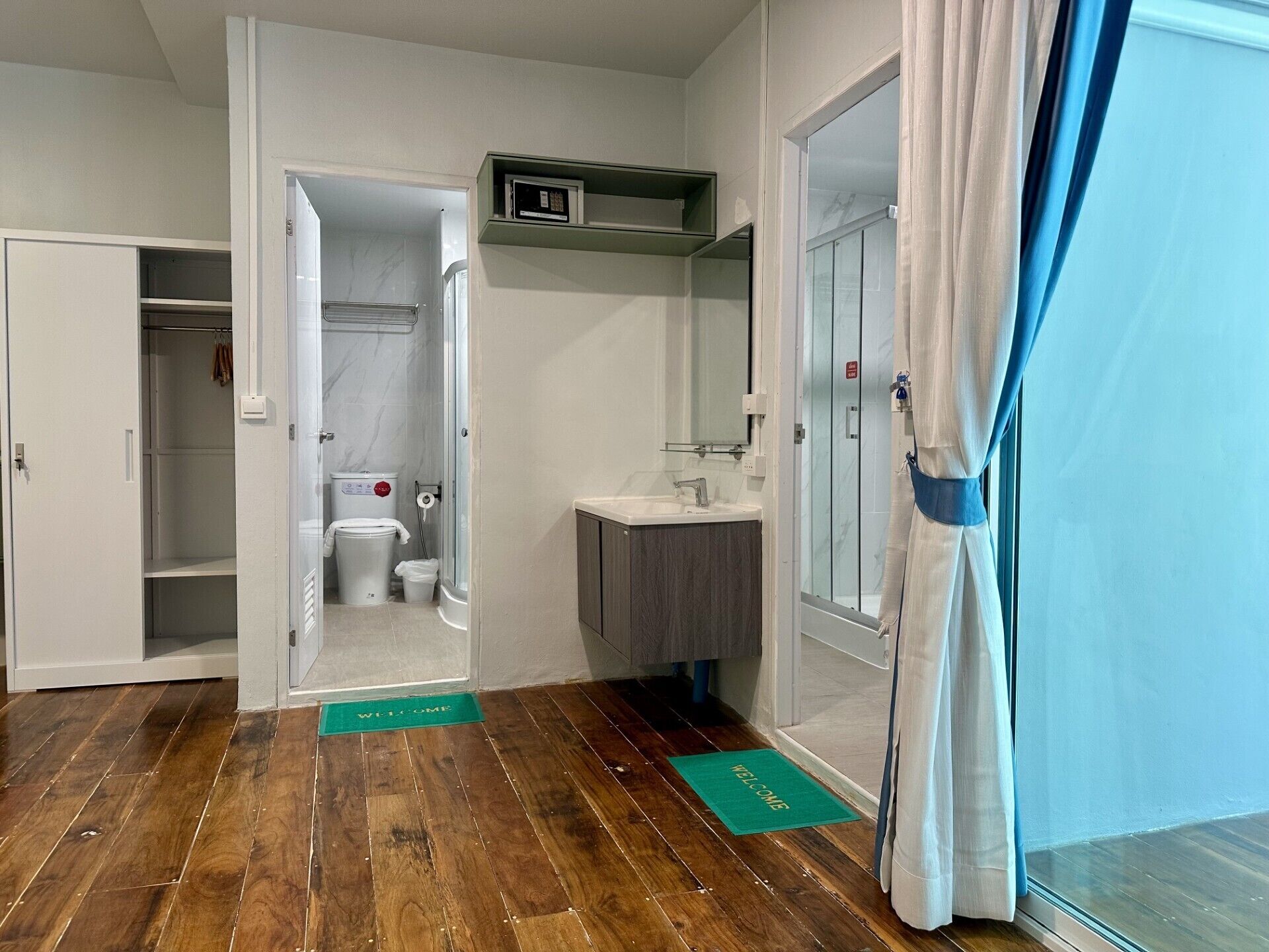 A compact bathroom with a shower, toilet, and sink.
