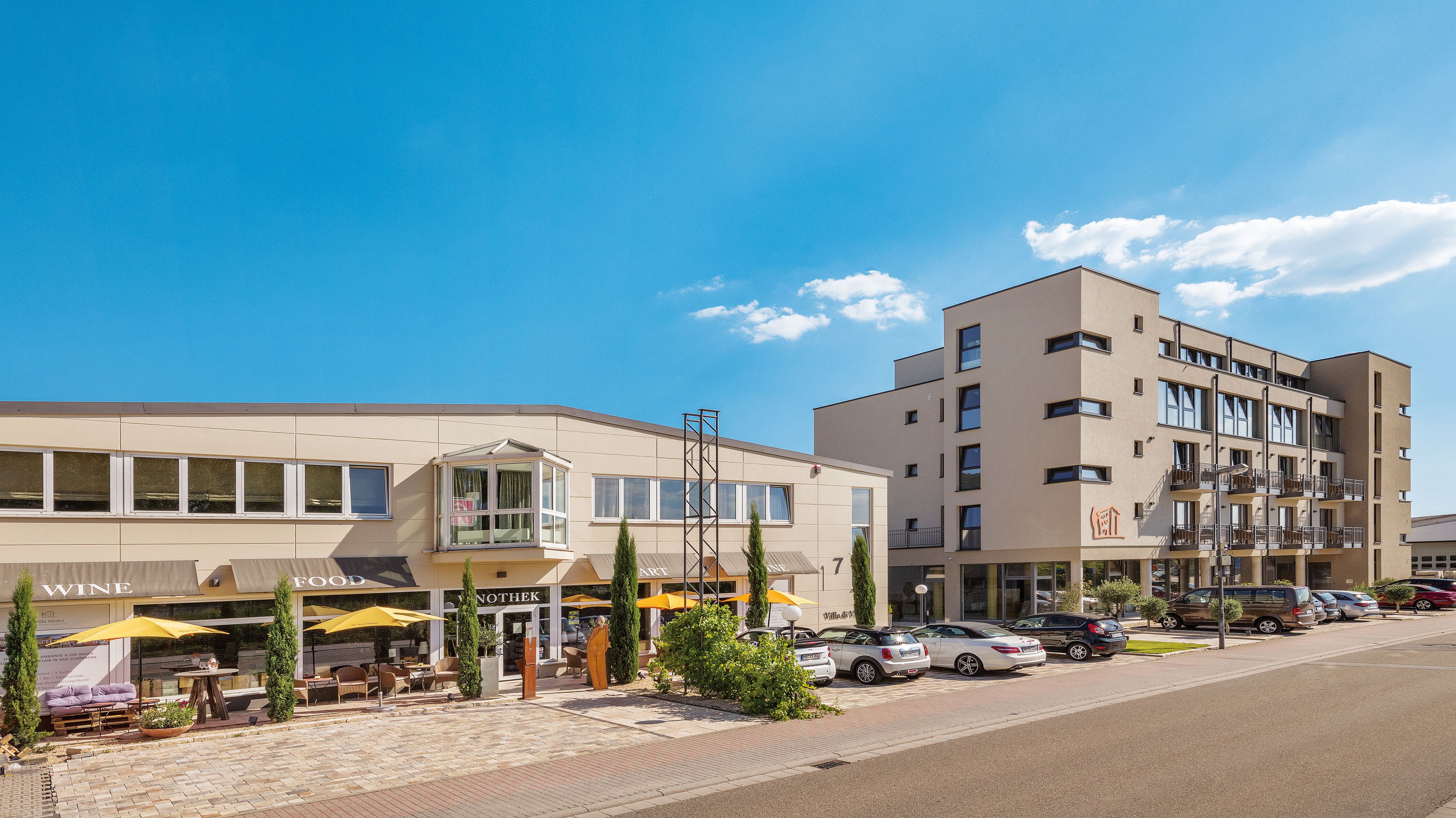 A building with a ground floor restaurant and a multi-story residential building.