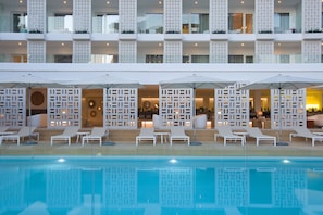 A hotel with a pool area featuring sun loungers and umbrellas, a modern architectural design with white balconies, and a clear blue pool. - HM Balanguera Beach- Adults Only (Palma de Mallorca)