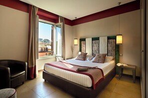 A hotel room with a large bed, a chair, a bedside table, and a window with curtains. - Trianon Borgo Pio (Rome)
