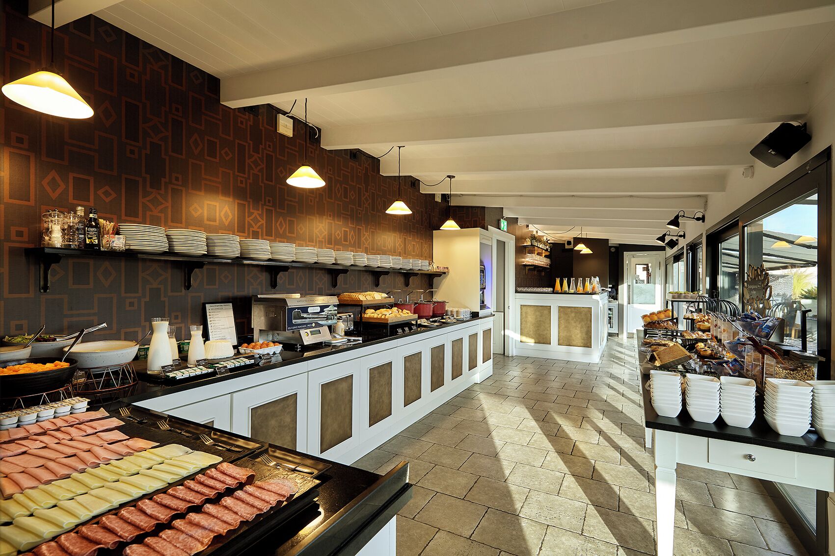 A buffet setup with various food items and a coffee station.