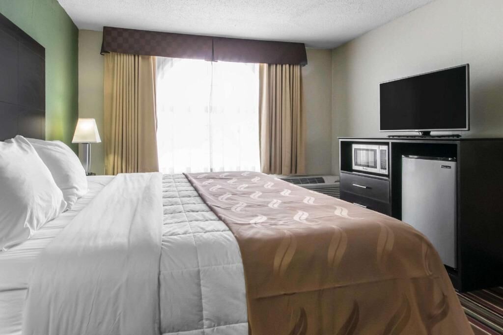 Desk, laptop workspace, blackout drapes, iron/ironing board