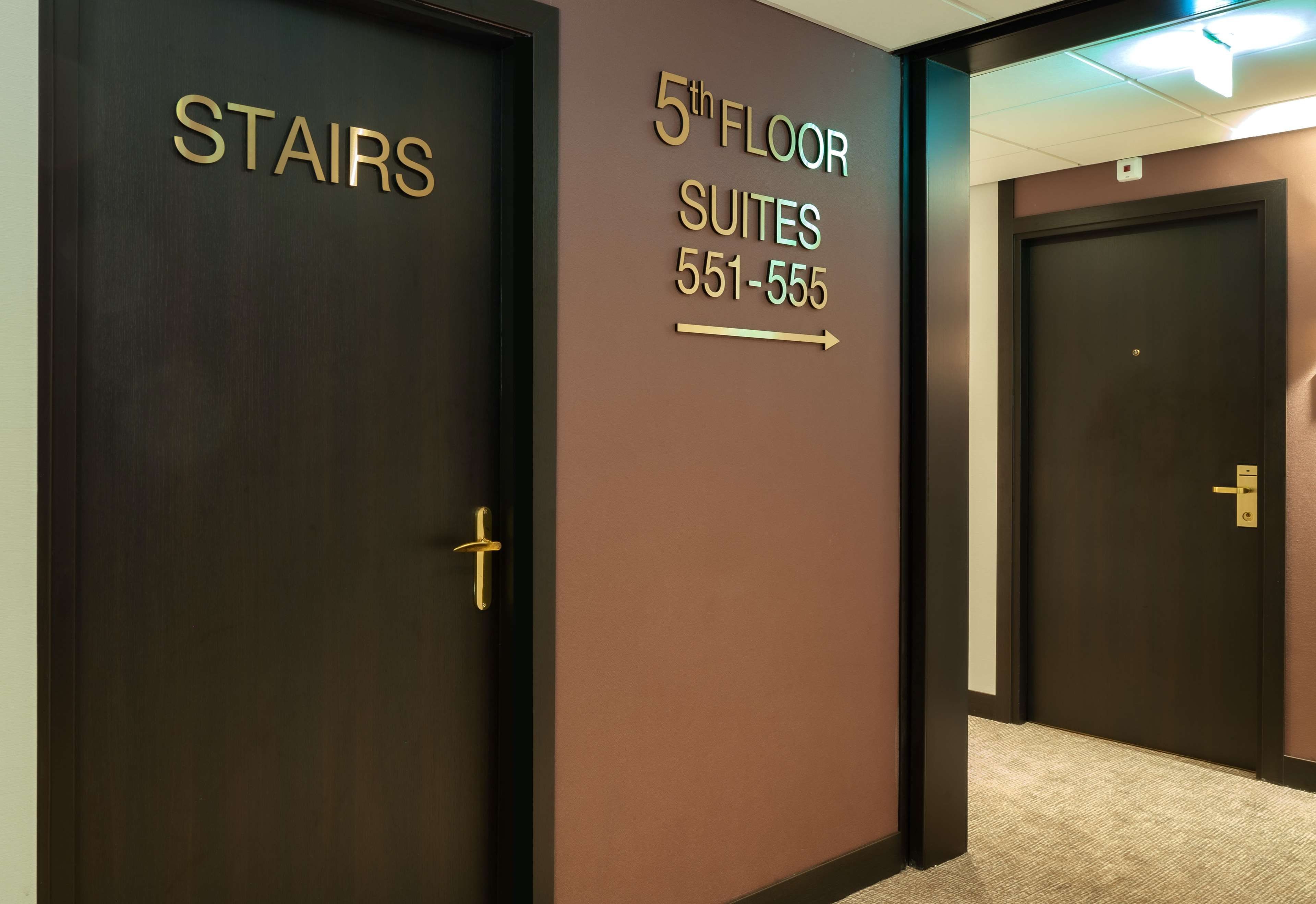 A hallway with doors labeled 'STAIRS' and '5th FLOOR SUITES 551-555'.