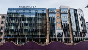 Standing tall with a striking glass facade, The Golden Tulip Hotel showcases its modern design.