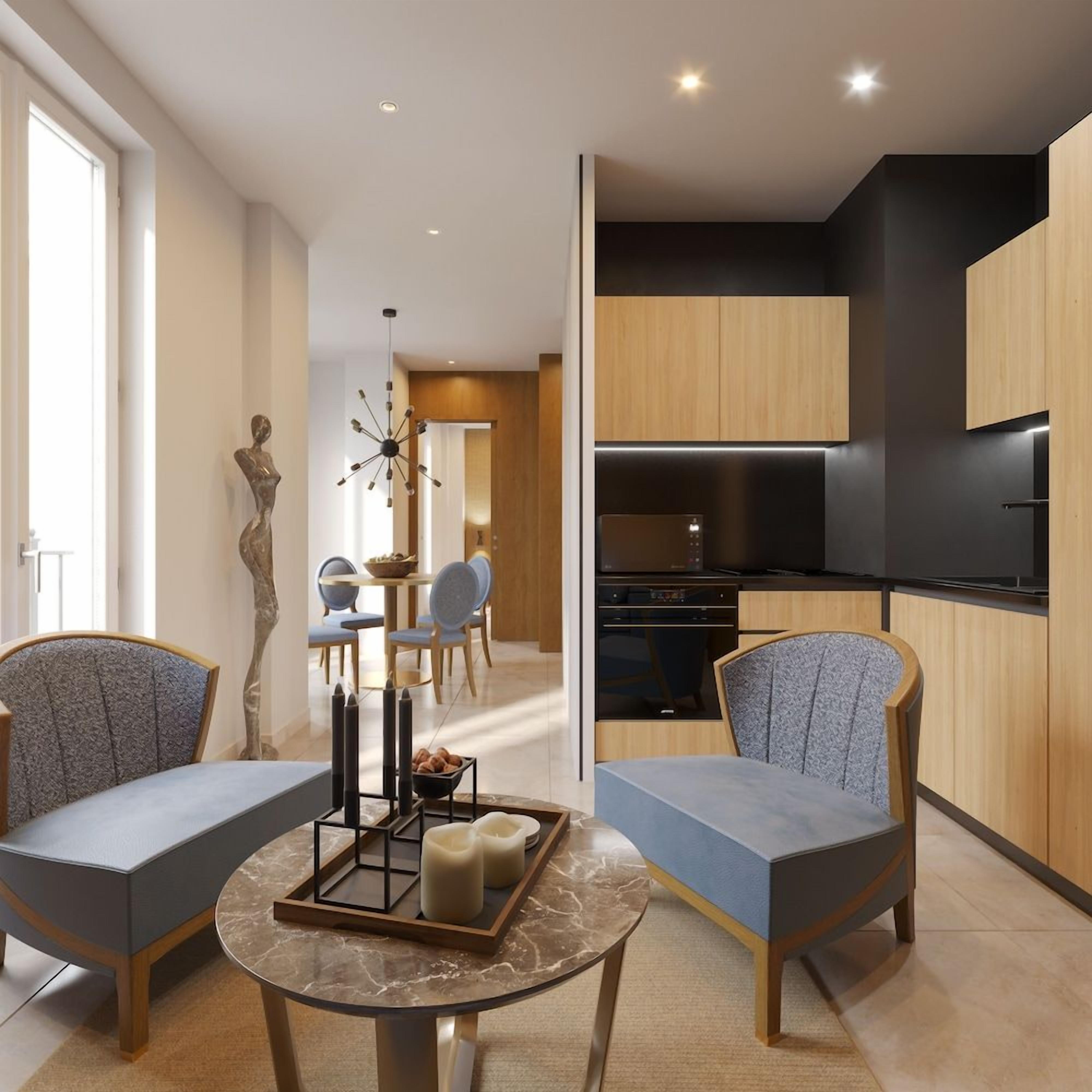 A modern living room with a marble table, two upholstered chairs, a sculpture, and a dining area with a chandelier.