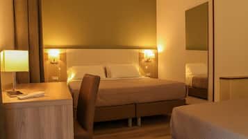 A hotel room with a bed, bedside tables, a desk, a chair, and a mirror.