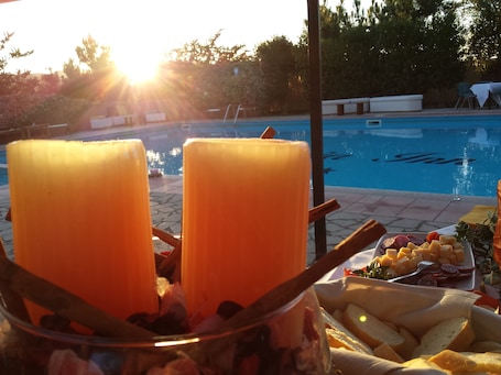 Seasonal outdoor pool, open 9:00 AM to 7:00 PM, pool umbrellas. Pausania Inn