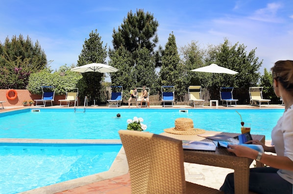 Seasonal outdoor pool, open 9:00 AM to 7:00 PM, pool umbrellas