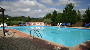 Seasonal outdoor pool, open 9:00 AM to 7:00 PM, pool umbrellas