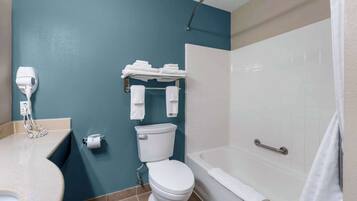 A bathroom with a toilet, a sink, a hairdryer, a towel rack, and a bathtub.