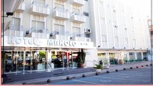 A hotel with a modern facade, multiple balconies, and a ground-level entrance with visible signage. - Hotel Manolo (Cartagena)