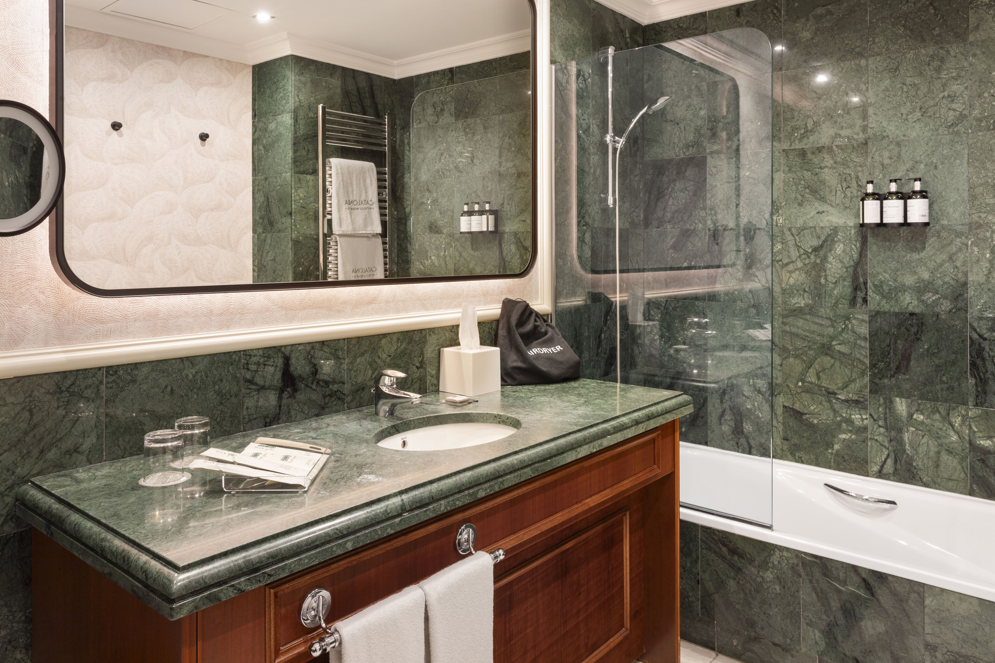 designer toiletries, hair dryer, towels