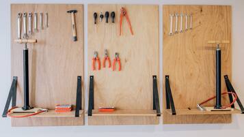 A pegboard wall with tools and a level.