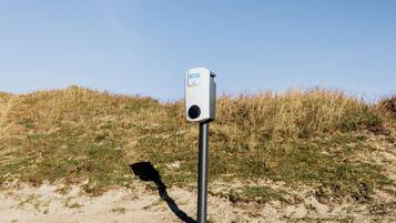 A portable device on a pole in a grassy area.