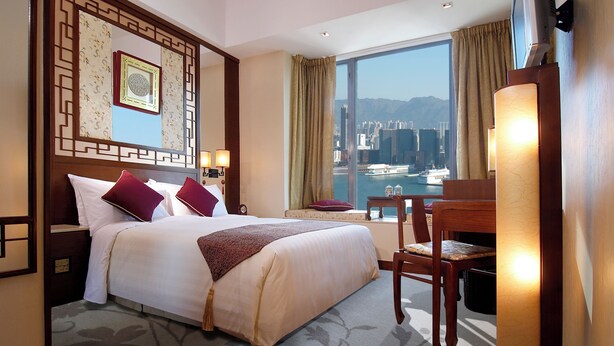 A hotel room with a large bed, a desk, and a view of a cityscape through the window. - Lan Kwai Fong Hotel @ Kau U Fong by Dorsett Hotels (Hong Kong)