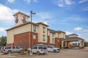 A hotel with a prominent Best Western Plus sign, multiple parking spaces, and a covered entrance. - Best Western Plus Lake Dallas Inn & Suites (Lake Dallas)