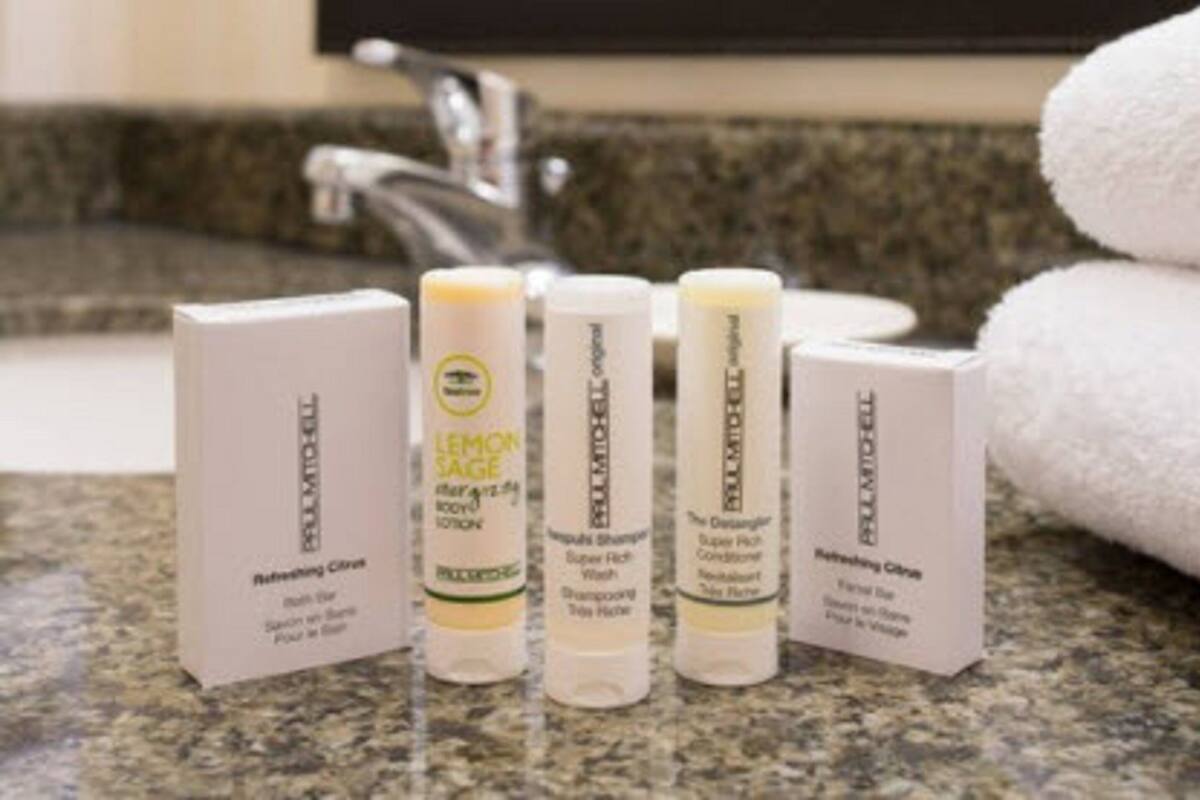 A bathroom counter with four toiletry items: Refreshing Citrus body wash, Lemon Sage body wash, Super Rich Wash body wash, and Refreshing Citrus body wash.