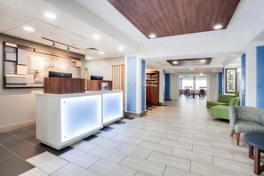 A hotel lobby with a reception desk, seating area, and a view of the outdoors. - Holiday Inn Express Hotel & Suites Clewiston by IHG (Clewiston)