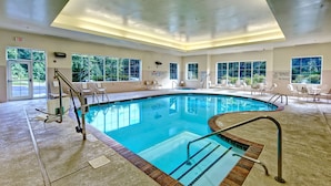 A large indoor swimming pool with clear lanes, a lifeguard station, and multiple seating areas. - Hampton Inn & Suites Cashiers Sapphire Valley (Sapphire)