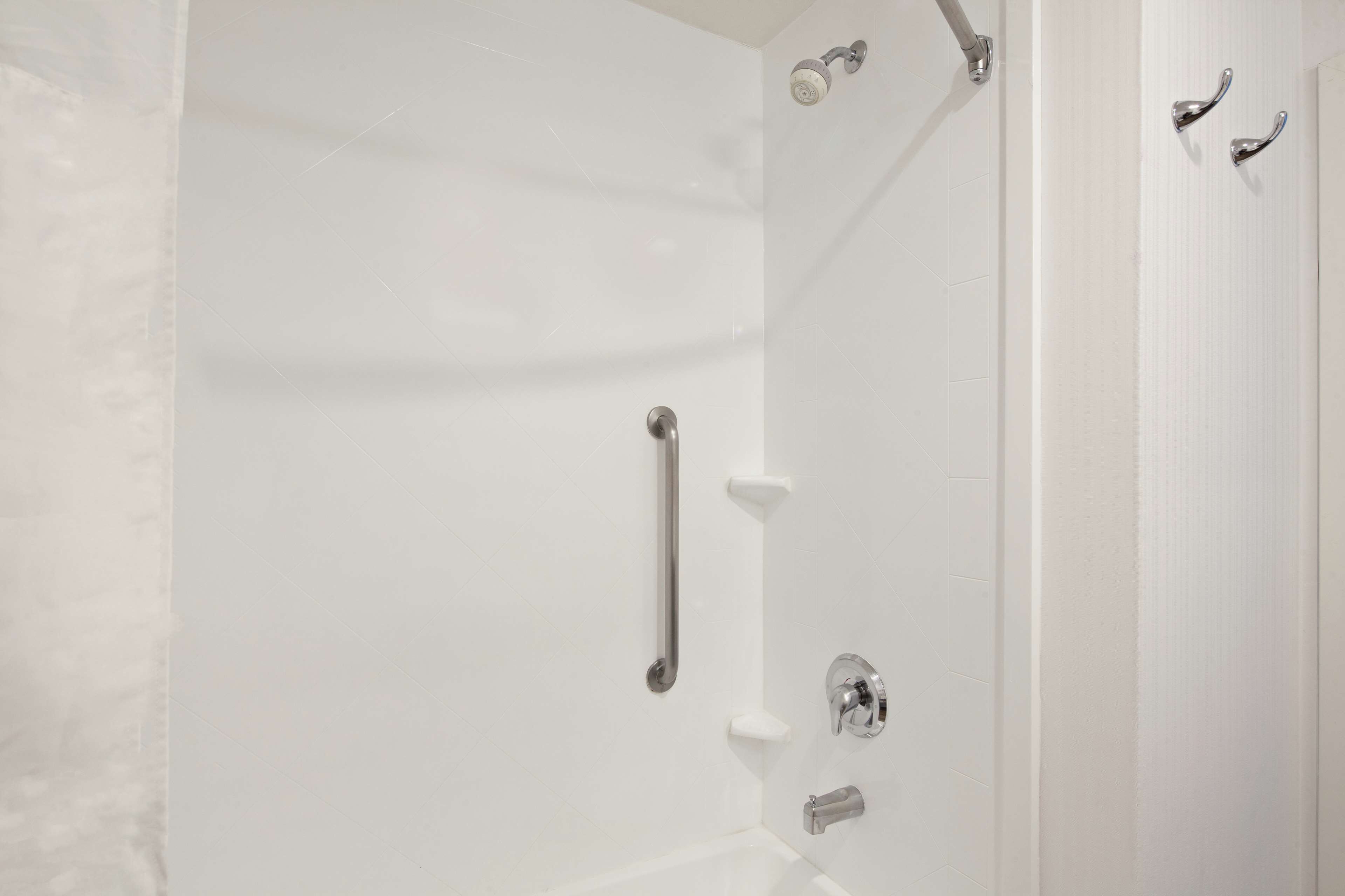 standard room with two queen beds | bathroom | hydromassage showerhead, free toiletries, hair dryer, towels