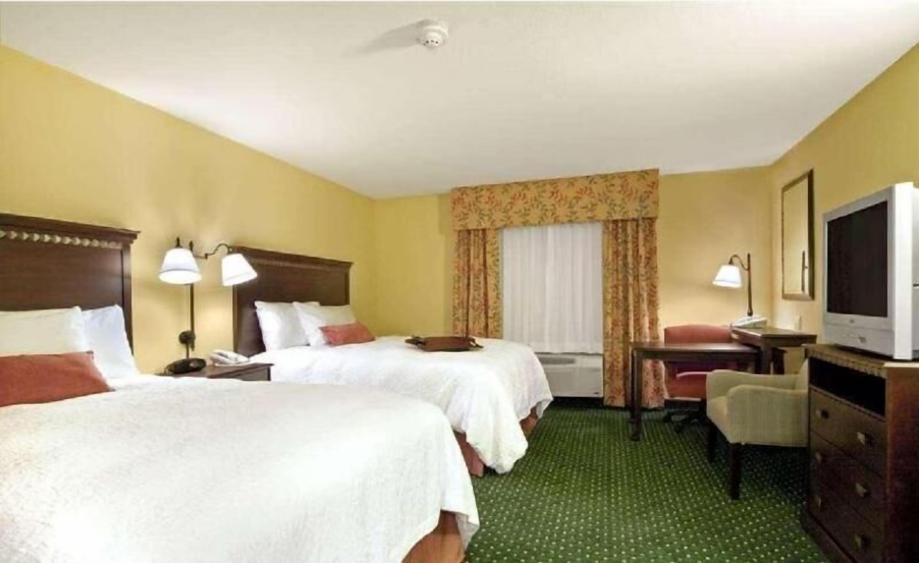 Premium bedding, desk, laptop workspace, blackout drapes