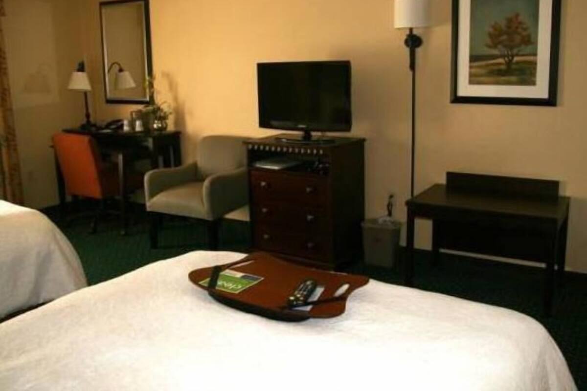 Premium bedding, desk, laptop workspace, blackout drapes